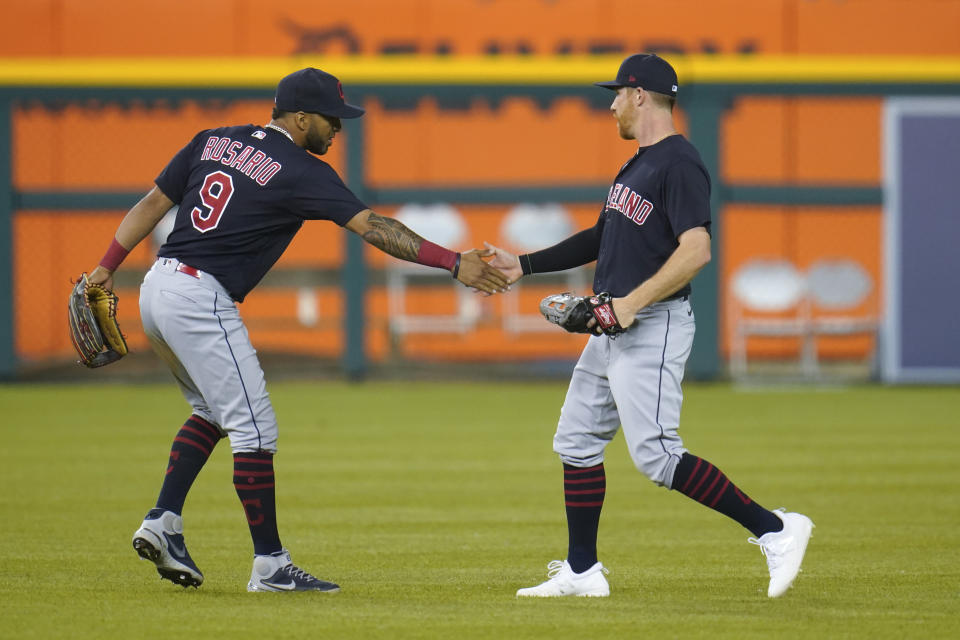 Cleveland Indians' Eddie Rosario (9) congratulates Jordan Luplow after the final out in the ninth inning of a baseball game against the Detroit Tigers in Detroit, Monday, May 24, 2021. Cleveland won 6-5. (AP Photo/Paul Sancya)