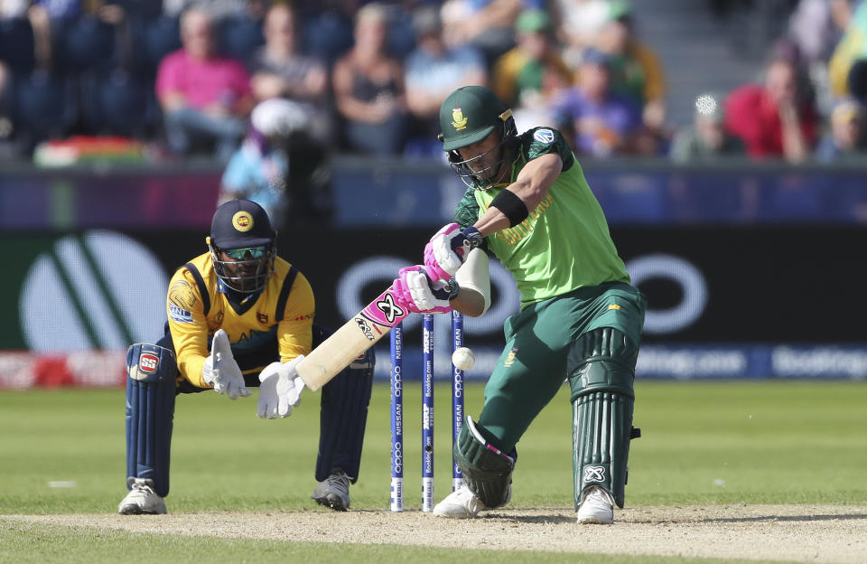 South Africa's captain Faf du Plessis, right, plays a shot as Sri Lanka's wicketkeeper Kusal Perera watches on during the Cricket World Cup match between Sri Lanka and South Africa at the Riverside Ground in Chester-le-Street, England, Friday, June 28, 2019. (AP Photo/Scott Heppell)