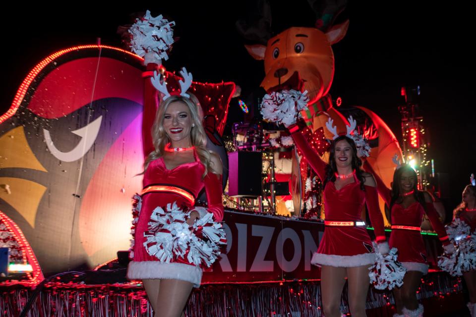 Arizona Cardinals cheerleaders walk at the APS Electric Light Parade on Saturday, Dec. 4, 2021, in Phoenix.