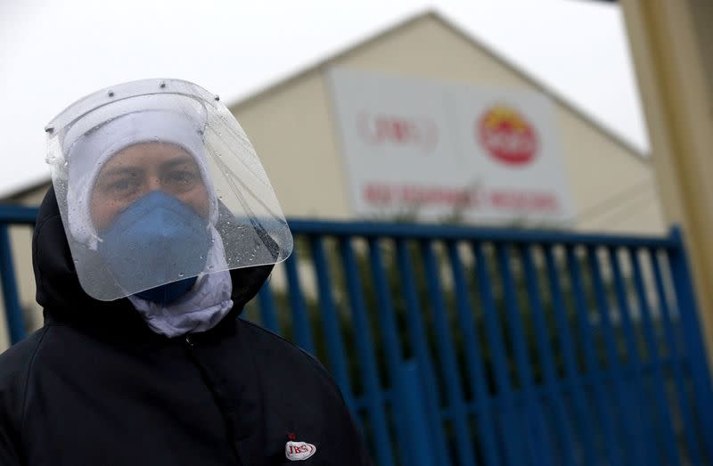 An employee of the JBS SA poultry factory wears a protective mask after the company was hit by an outbreak of coronavirus disease (COVID-19) in Passo Fundo