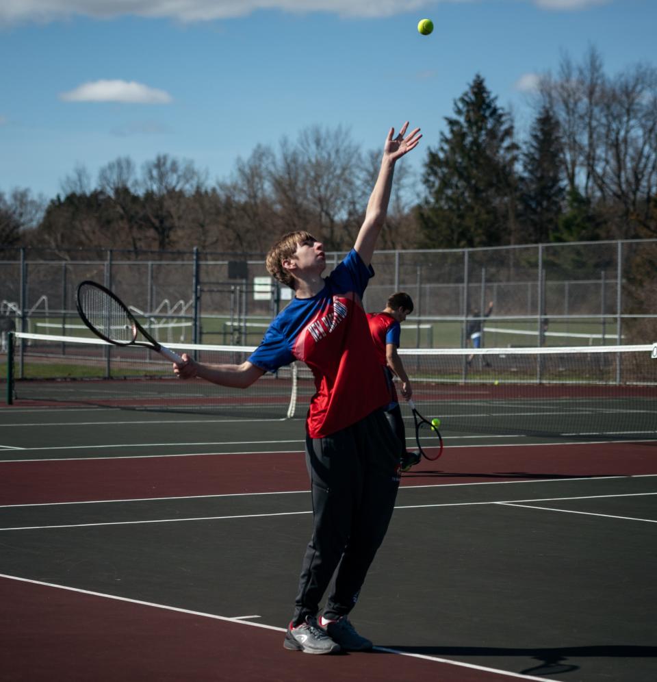 David Fenner serves the ball for New Hartford in his singles match against Whitesboro at Marcy Elementary School in Marcy on Wednesday, April 20, 2022.