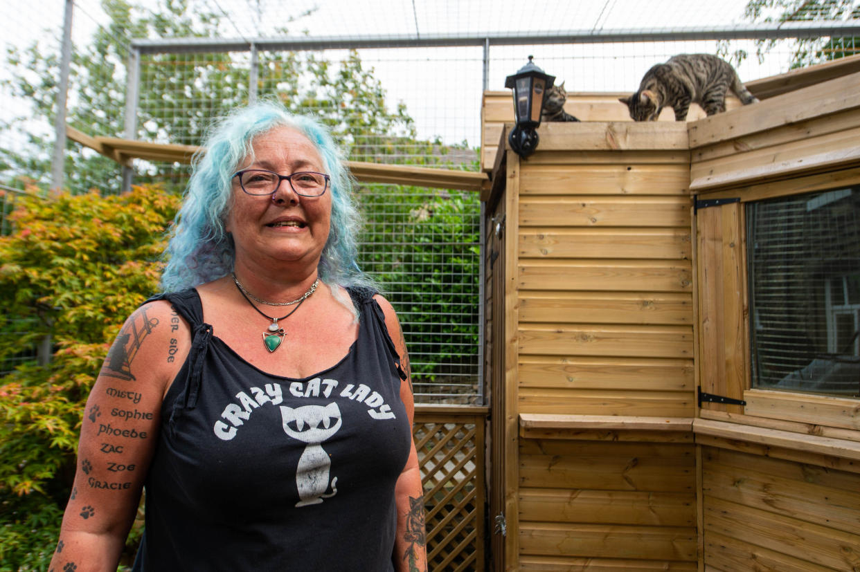 Sue Haworth in the cage for her cats at her home (Picture: SWNS)