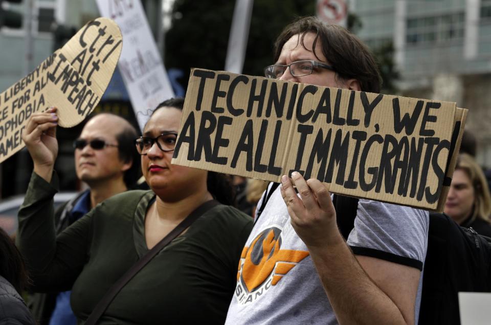 In this Monday, Feb. 13, 2017 photo, tech workers hold signs as they protest Trump administration policies in San Francisco. In the wake of the 2016 election, old-school, anti-capitalist activists and new-school, free-enterprise techies in the city are pushing aside their differences to take on a common foe. (AP Photo/Ben Margot)