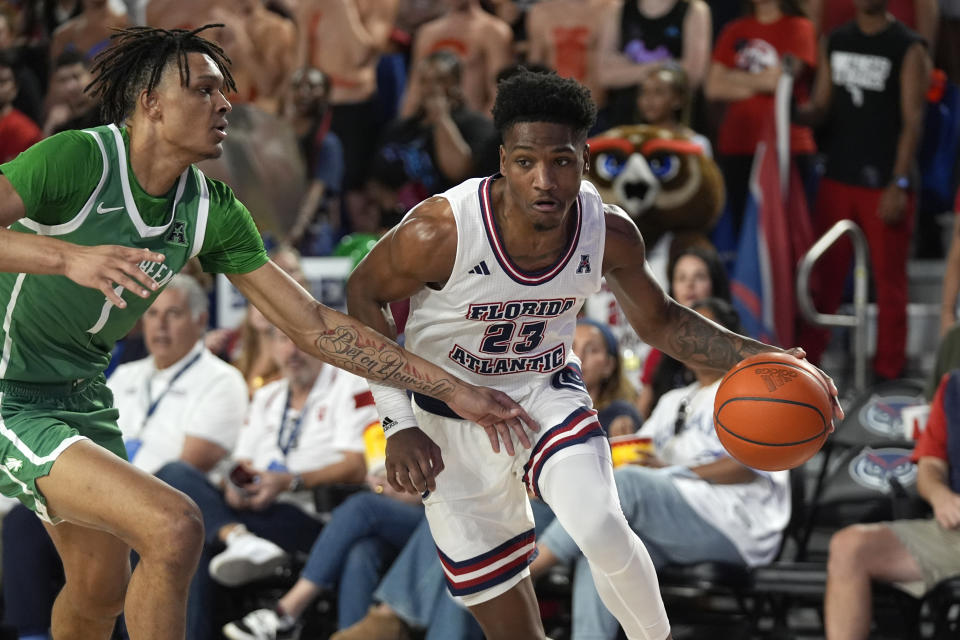 Florida Atlantic guard Brandon Weatherspoon (23) drives to the basket against North Texas forward Aaron Scott (1) during the first half of an NCAA college basketball game, Sunday, Jan. 28, 2024, in Boca Raton, Fla. (AP Photo/Wilfredo Lee)