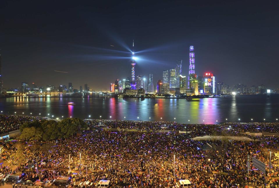 People watch a light show before a stampede incident occurred at the New Year's celebration on the Bund, a waterfront area in central Shanghai