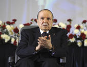 FILE - In this April 28, 2014, file photo, Algerian President Abdelaziz Bouteflika, sitting in a wheelchair, applauds after taking the oath as President in Algiers. Former Algerian President Bouteflika, who fought for independence from France in the 1950s and 1960s and was ousted amid pro-democracy protests in 2019 after 20 years in power, has died at age 84, state television announced Friday, Sept. 17, 2021. (AP Photo/Sidali Djarboub, File)