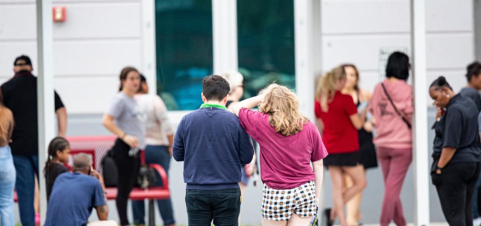 Parent  from South Fort Myers High School wait to reunite with students after a threat of a gun was called in Friday afternoon. Lee County SheriffÕs Office declared that there was no active shooter after officers searched the school.