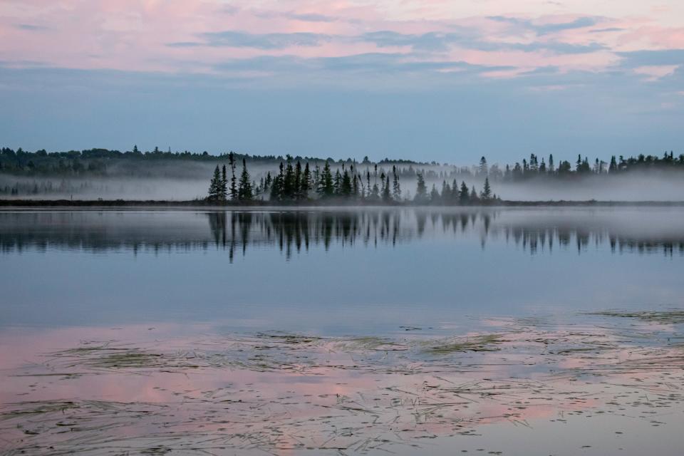 Fog sets in over Boot Lake during sunset in the Boundary Waters Canoe Area Wilderness in September 2023. Scientists and environmental advocates worry how climate change will affect this beloved tourist destination.