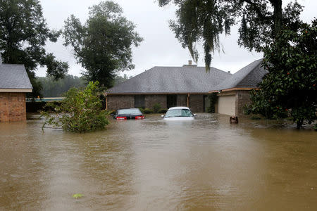 Houses and cars are seen partially submerged by flood waters from tropical storm Harvey in east Houston, Texas, U.S., August 28, 2017. REUTERS/Jonathan Bachman