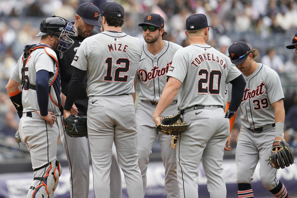 Detroit Tigers pitcher Casey Mize (12) confers with pitching coach Chris Fetter, second from left, in the third inning of a baseball game against the New York Yankees, Saturday, May 4, 2024, in New York. (AP Photo/Mary Altaffer)