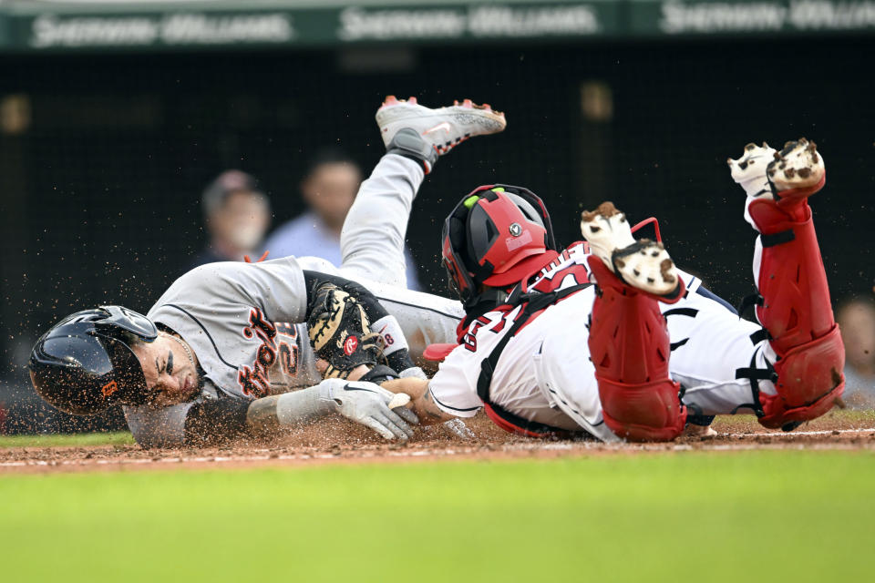 Detroit Tigers' Javier Báez, left, is tagged out at home plate by Cleveland Guardians' Cam Gallagher during the third inning of a baseball game, Tuesday, May 9, 2023, in Cleveland. (AP Photo/Nick Cammett)
