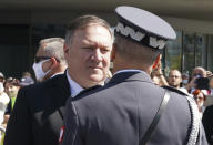 US Secretary of State Mike Pompeo talks to an officer at Pilsudski square in Warsaw, Poland, before ceremonies commemorating the 100th anniversary of the Battle of Warsaw, Saturday Aug. 15, 2020. Pompeo is on a five day visit to central Europe. (Janek Skarzynski/Pool via AP)