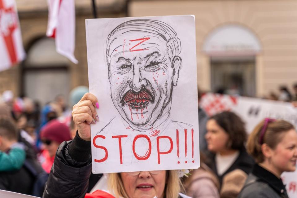 The protester holds a banner with the image of Lukashenko with the letter Z on his forehead, a symbol of the war in Ukraine on March 24, 2024 in Warsaw, Poland. (Marek Antoni Iwanczuk/SOPA Images/LightRocket via Getty Images)