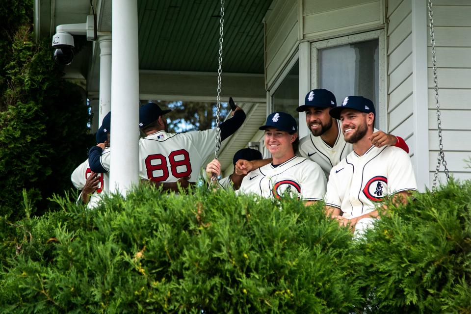 Chicago Cubs players pose for a photo on the porch of the house featured in "Field of Dreams" before Thursday's Major League Baseball game against the Cincinnati Reds in Dyersville.