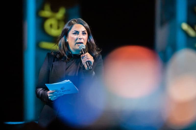 Human rights activist Duezen Tekkal speaks during a protest action for solidarity with the protests in Iran at the Brandenburg Gate. Christoph Soeder/dpa