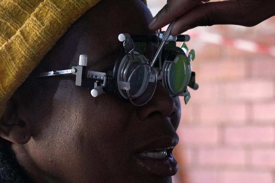 A patient eyes are tested for lenses to be made for a new pair of glasses outside the Phelophepa eye clinic carriage, in Tembisa east of Johannesburg, South Africa, Thursday, Aug. 22, 2024. (AP Photo/Themba Hadebe)