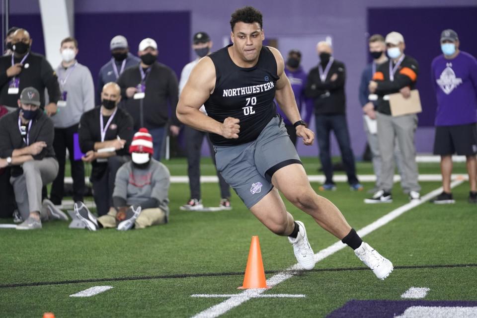 Northwestern offensive lineman Rashawn Slater participates in the school's pro day workout.