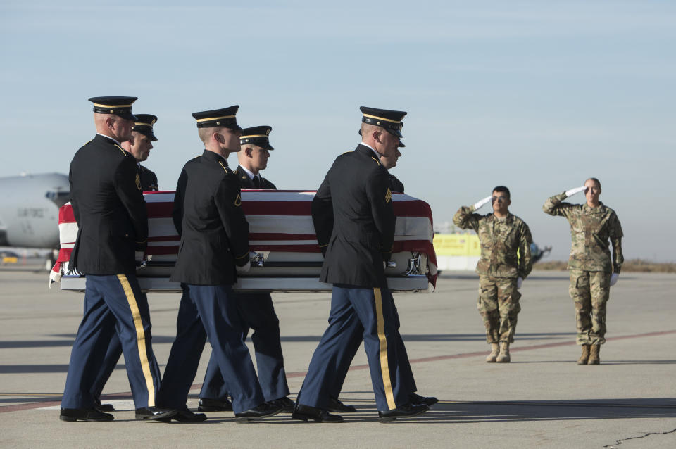 Utah National Guard Honor Guard carry a casket containing the remains of Maj. Brent R. Taylor at the National Guard base Wednesday, Nov. 14, 2018. in Salt Lake City. The remains of a Utah mayor killed while serving in the National Guard in Afghanistan were returned to his home state on Wednesday, Nov. 14, 2018, as hundreds of soldiers saluted while his casket covered in an American flag was carried across a tarmac and into a hearse. (Matt Herp/Standard-Examiner, via, Pool)