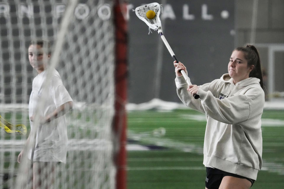 Northwestern lacrosse player Izzy Scane warms up during practice in Evanston, Ill., Tuesday, Feb. 6, 2024. (AP Photo/Nam Y. Huh)