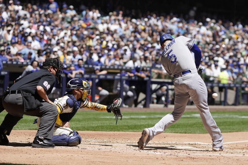 Los Angeles Dodgers' Freddie Freeman hits a two-run scoring single during the fifth inning of a baseball game against the Milwaukee Brewers Wednesday, May 10, 2023, in Milwaukee. (AP Photo/Morry Gash)