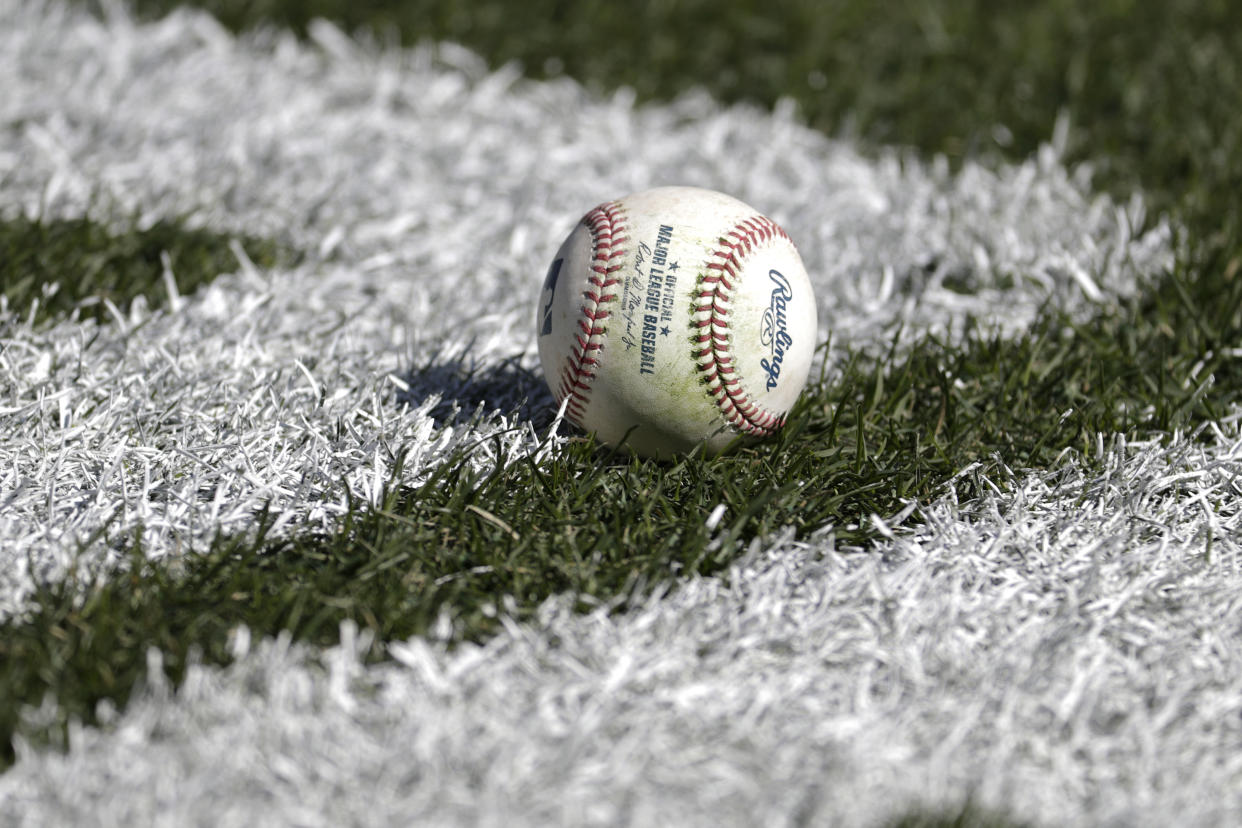A baseball rests on the field prior to an opening day baseball game between the New York Yankees and the Baltimore Orioles at Yankee Stadium, Thursday, March 28, 2019, in New York. (AP Photo/Julio Cortez)