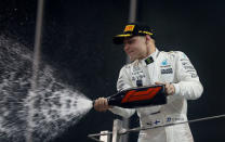 Formula One - Abu Dhabi Grand Prix - Yas Marina circuit, Abu Dhabi, United Arab Emirates - November 26, 2017 Mercedes' Valtteri Bottas sprays champagne as he celebrates winning the race REUTERS/Hamad I Mohammed