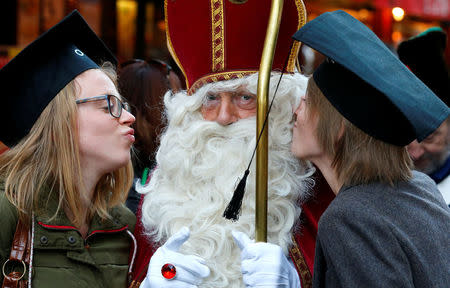 Saint Nicholas poses with students during a traditional parade in central Brussels, Belgium December 3, 2016. REUTERS/Yves Herman