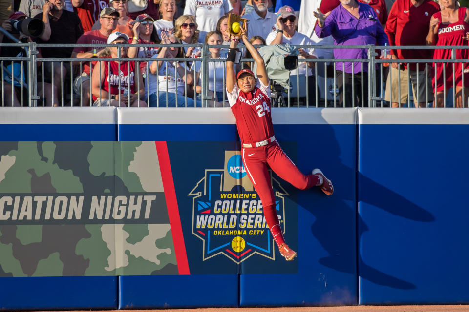 Jun 8, 2023; Oklahoma City, OK, USA;  Oklahoma Sooners outfielder Jayda Coleman (24) makes a catch at the wall in the third inning against the Florida State Seminoles during game two of the Women&#39;s College World Series finals at OGE Energy Field at the USA Softball Hall of Fame Complex. Oklahoma won the game 3-1 and the National Championship. Mandatory Credit: Brett Rojo-USA TODAY Sports