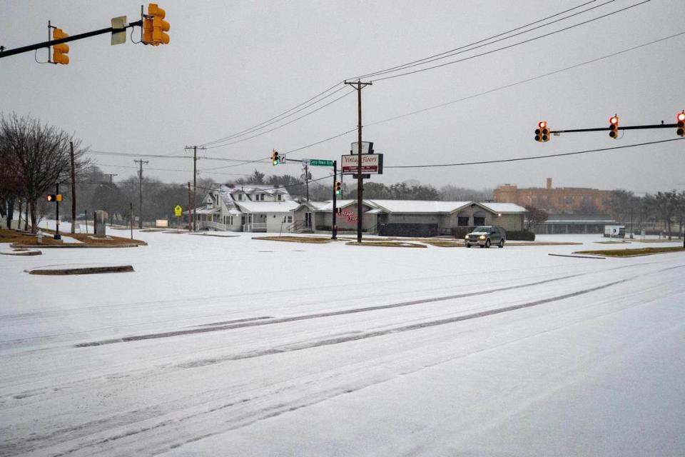 Tire tracks break up icy roads in Fort Worth on Tuesday, Jan. 31, 2023. Winter storm conditions have extended through Thursday morning as freezing rain continues.