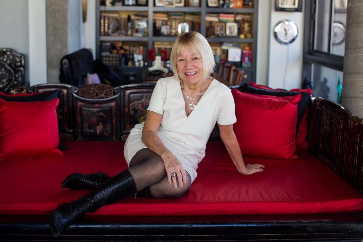 Cindy Gallop in white dress and black boots