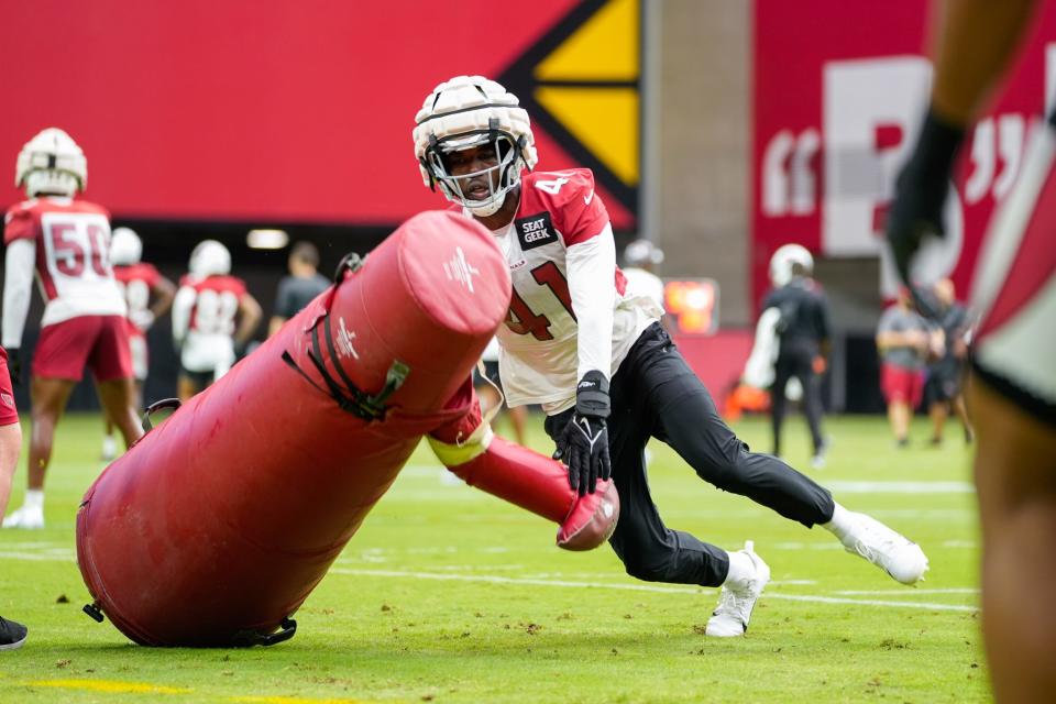 Arizona Cardinals outside linebacker Myjai Sanders (41) pushes over a tackling dummy during the Cardinals’ first public practice of the season at State Farm Stadium in Glendale on July 30, 2022.