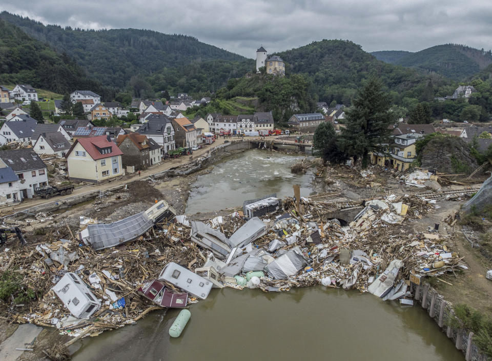 Caravans, gas tanks, trees and scrap pile up metres high on a bridge over the Ahr in Altenahr, Germany, Monday, July 19, 2021. Numerous houses in the town were completely destroyed or severely damaged, there are numerous fatalities. (Boris Roessler/dpa via AP)