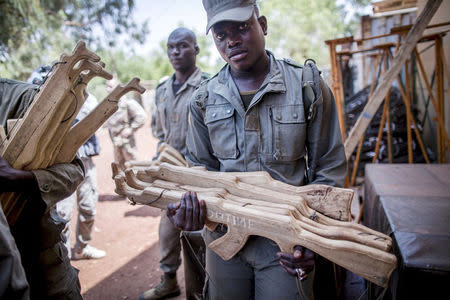 A Malian soldier carries mock weaponry for training during the visit of German Defence Minister Ursula von der Leyen (unseen) to the EUTM military training mission in Koulikoro, Mali, April 6, 2016. To match Analysis MALI-SECURITY/ REUTERS/Michael Kappeler/Pool/File Photo