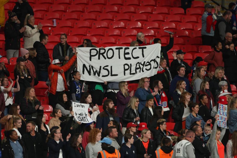 Fans hoist a banner in support of players after a report was released documenting systemic abuse in the National Women’s Soccer League. <a href="https://www.gettyimages.com/detail/news-photo/fans-hold-up-a-banner-saying-protect-nwsl-players-during-news-photo/1243801782?phrase=national%20women's%20soccer%20league&adppopup=true" rel="nofollow noopener" target="_blank" data-ylk="slk:Matthew Ashton/AMA via Getty Images;elm:context_link;itc:0;sec:content-canvas" class="link ">Matthew Ashton/AMA via Getty Images</a>