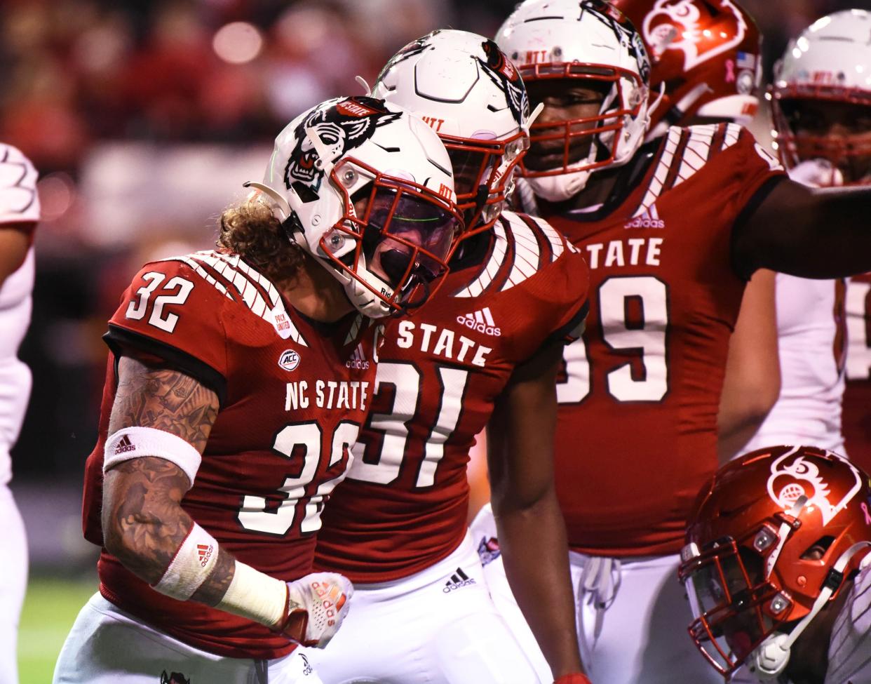 Oct 30, 2021; Raleigh, North Carolina, USA; North Carolina State Wolfpack linebacker Drake Thomas (32) reacts after a tackle during the first half against the Louisville Cardinals at Carter-Finley Stadium. Mandatory Credit: Rob Kinnan-USA TODAY Sports