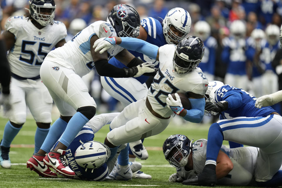Tennessee Titans running back Derrick Henry (22) is tackled by Indianapolis Colts linebacker Zaire Franklin, below, during the second half of an NFL football game, Sunday, Oct. 8, 2023, in Indianapolis. (AP Photo/Michael Conroy)