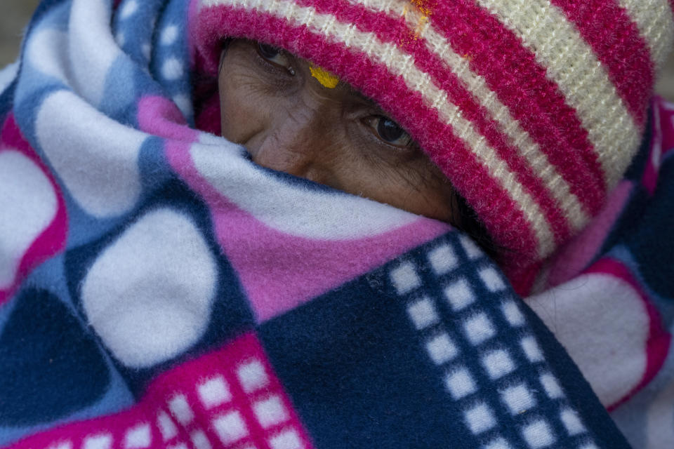 An Indian pilgrim who is embarked on a visit to the sacred Pashupatinath temple takes rest in Kathmandu, Nepal, Jan. 12, 2024. The centuries-old temple is one of the most important pilgrimage sites in Asia for Hindus. Nepal and India are the world’s two Hindu-majority nations and share a strong religious affinity. Every year, millions of Nepalese and Indians visit Hindu shrines in both countries to pray for success and the well-being of their loved ones. (AP Photo/Niranjan Shrestha)