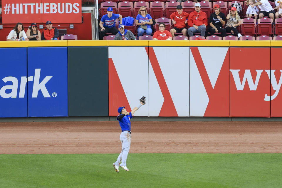 Chicago Cubs' Seiya Suzuki leaps to make a catch for an out on a ball hit by Cincinnati Reds' Michael Siani during the third inning of a baseball game in Cincinnati, Friday, Wednesday, Oct. 5, 2022. (AP Photo/Aaron Doster)