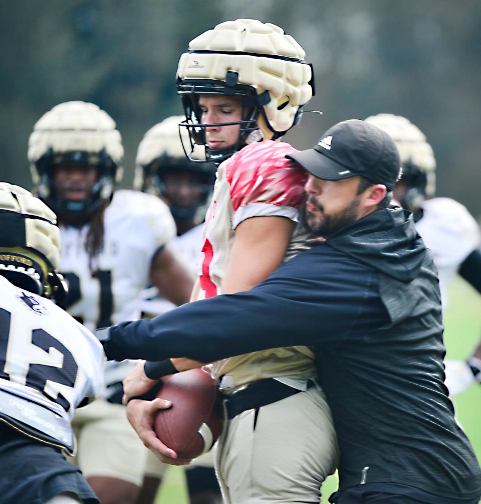 Wofford assistant football coach Dane Romero on the field going through drills on Sept 7, 2021.