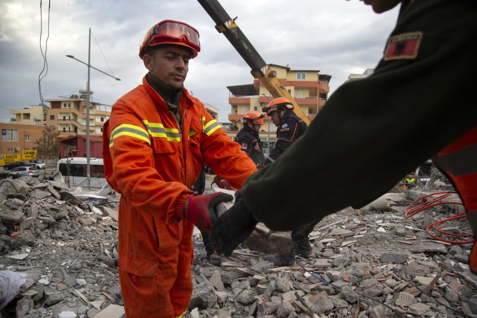 In this photo taken on Thursday, Nov. 28, 2019, rescuers from Turkey search with their Albanian colleagues at a collapsed building after the 6.4-magnitude earthquake in Durres, western Albania.In the initial hours after a deadly pre-dawn earthquake struck Albania, pancaking buildings and trapping dozens of sleeping people beneath the rubble, the country’s neighbors sprang into action. Offers of help flooded in from across Europe and beyond, with even traditional foes setting aside their differences in the face of the natural disaster. The 6.4-magnitude earthquake that struck Albania on Tuesday killed at least 49 people, injured 2,000 and left at least 4,000 homeless. (AP Photo/Visar Kryeziu)