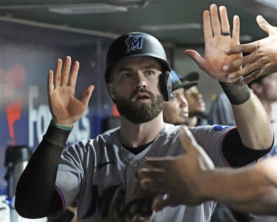 Miami Marlins' Jon Berti, center, celebrates in the dugout after scoring on a fielders choice by Jorge Soler off Pittsburgh Pirates relief pitcher Dauri Moreta during the sixth inning of a baseball game in Pittsburgh, Saturday, Sept. 30, 2023. (AP Photo/Gene J. Puskar)