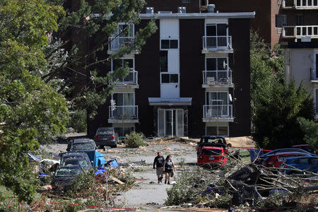 People look at the damage after a tornado hit the Mont-Bleu neighbourhood in Gatineau, Quebec, Canada, September 22, 2018. REUTERS/Chris Wattie