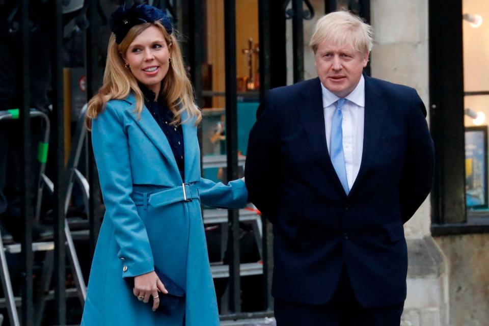 Boris Johnson (R) with his partner Carrie Symonds (AFP via Getty Images)