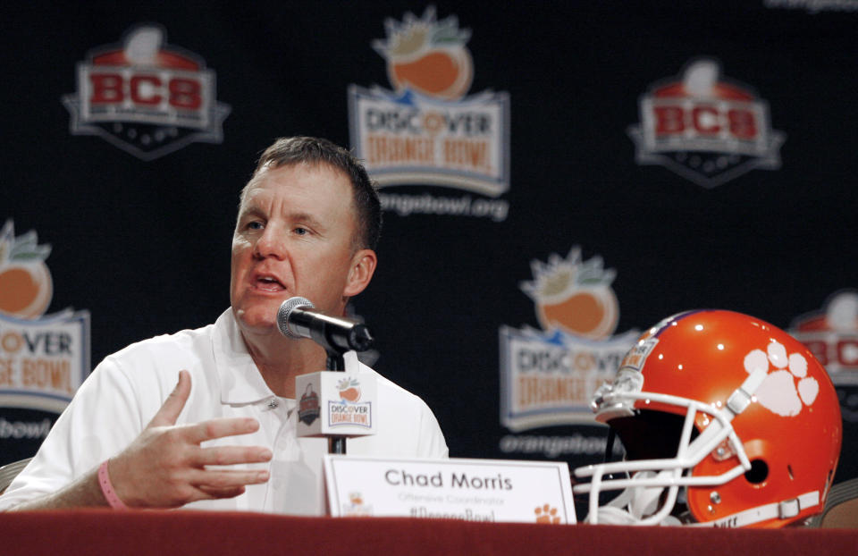 FILE - In this Dec. 31, 2011, file photo, Clemson offensive coordinator Chad Morris speaks to reporters during an NCAA college football news conference in Fort Lauderdale, Fla. Salaries for coordinators continue to rise in the ACC, as they do around college football. But Clemson has taken it to a new level. The defending Atlantic Coast Conference champions are paying a combined $2.1 million this season for their coordinators. Second-year offensive leader Chad Morris is the highest paid assistant in college football at $1.3 million a year. (AP Photo/Jeffrey M. Boan, File)