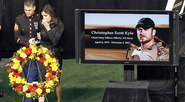 Christopher Kyle's wife, Taya, is escorted to her seat after memorialising her husband in Arlington, Texas. Photo: AP