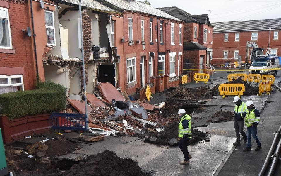 Manchester: Houses this morning on Walmer Street in Abbey Hey, Manchester. They fell into a giant sinkhole yesterday following heavy rainfall - Mercury Press