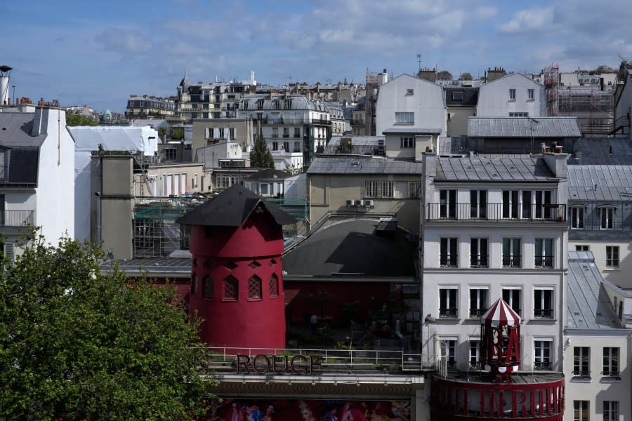 The Moulin Rouge (Red Mill) is seen Thursday, April 25, 2024 in Paris. The windmill from the Moulin Rouge, the 19th century Parisian cabaret, has fallen off the roof overnight along with some of the letters in its name. (AP Photo/Thibault Camus)