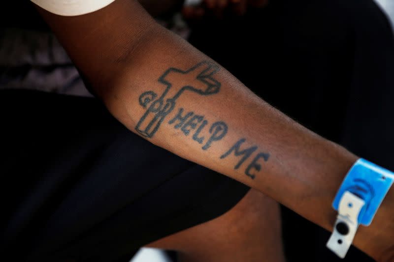 An Ethiopian asylum seeker displays his tattoo, at the Um Rakuba refugee camp which houses Ethiopians fleeing the fighting in the Tigray region