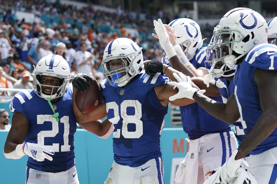 Indianapolis Colts running back Jonathan Taylor (28) celebrates with teammates including Indianapolis Colts running back Nyheim Hines (21), left, after scoring a touchdown during the first half of an NFL football game against the Miami Dolphins, Sunday, Oct. 3, 2021, in Miami Gardens, Fla. (AP Photo/Lynne Sladky)