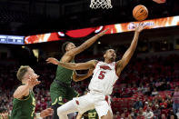 Arkansas guard Au'Diese Toney (5) drives past Charlotte defenders Austin Butler (2) and Jahmir Young (1) for a lay-up in the first half of an NCAA college basketball game Tuesday, Dec. 7, 2021, in Fayetteville, Ark. (AP Photo/Michael Woods)